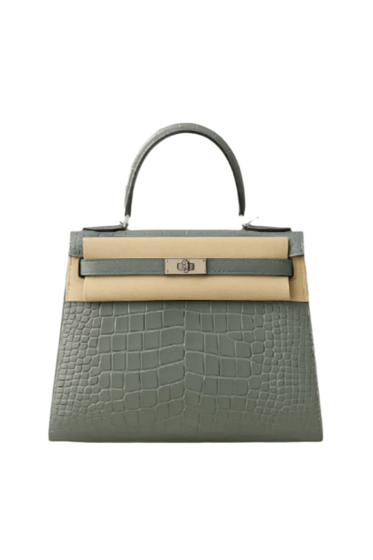 Gray and beige handbag with crocodile texture on a beige background